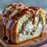 A close-up slice of Caramel Cream Cheese Bread reveals a creamy cheesecake-like center and rich caramel ribbon.