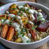 Vibrant roasted root vegetable bowl with caramelized turnips and parsnips, fluffy quinoa, and a glossy tahini drizzle for a wholesome meal.  