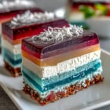 Close-up of layered agar-agar rainbow jelly cake, showcasing smooth, fruity textures.