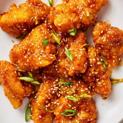 Sticky-sweet Orange Chicken with steamed broccoli and jasmine rice, perfect for a takeout-style homemade dinner.
