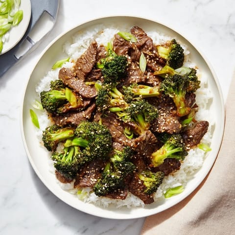 Tossing tender beef and crisp broccoli in a wok for a quick Beef and Broccoli stir-fry.