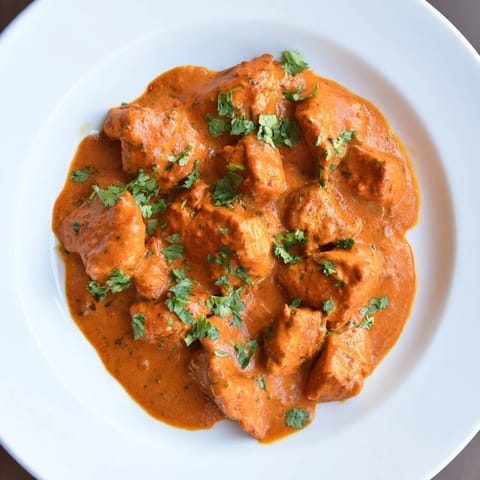 Golden-broiled Chicken Tikka Masala pieces simmer in a spiced tomato cream sauce.