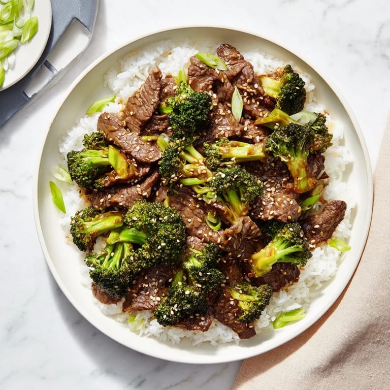Tossing tender beef and crisp broccoli in a wok for a quick Beef and Broccoli stir-fry.